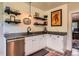 Charming kitchen features granite countertops, white cabinetry, and stylish open shelving at 3396 S Logan St, Englewood, CO 80113