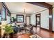 Comfortable living room with hardwood floors, dark wood trim, a plush blue sofa, and ample natural light at 3396 S Logan St, Englewood, CO 80113