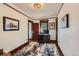 A well-lit home office featuring warm hardwood trim and a modern, neutral-toned rug at 3396 S Logan St, Englewood, CO 80113