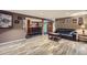Spacious finished basement area with sleek flooring, a comfortable couch and a bar at 8600 W 2Nd Ave, Lakewood, CO 80226