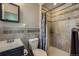 Bathroom features modern fixtures, a shower and vanity with tile backsplash at 8600 W 2Nd Ave, Lakewood, CO 80226