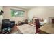 Versatile bedroom space with a large window and a variety of furniture at 8600 W 2Nd Ave, Lakewood, CO 80226
