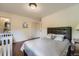 Bedroom featuring hard wood floors, a Queen size bed, and a crib at 8600 W 2Nd Ave, Lakewood, CO 80226