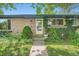Inviting brick home entrance with a well-kept lawn and lush landscaping at 8600 W 2Nd Ave, Lakewood, CO 80226