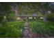 Charming home with lush landscaping, walkway, and inviting entrance at 8600 W 2Nd Ave, Lakewood, CO 80226