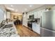 Spacious kitchen with granite countertops, stainless steel appliances, and hardwood floors at 8600 W 2Nd Ave, Lakewood, CO 80226