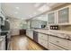Well-lit kitchen featuring granite countertops, modern appliances, and hardwood flooring at 8600 W 2Nd Ave, Lakewood, CO 80226
