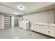 Spacious laundry room with washer, dryer, built-in shelving, and utility sink at 8600 W 2Nd Ave, Lakewood, CO 80226