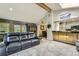 Open-concept living room featuring a large comfortable sofa and an adjacent kitchen view at 8600 W 2Nd Ave, Lakewood, CO 80226