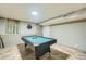 Finished basement recreation room with a pool table, wall decor, and overhead lighting at 8600 W 2Nd Ave, Lakewood, CO 80226