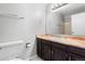 Bathroom featuring a single sink vanity, a full mirror and tiled floors at 3293 S Fairplay St, Aurora, CO 80014