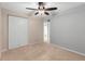 Carpeted bedroom featuring a ceiling fan and closet with bi-fold doors at 3293 S Fairplay St, Aurora, CO 80014