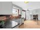 Modern kitchen with granite countertops, stainless steel appliances, and brick accent wall at 3293 S Fairplay St, Aurora, CO 80014