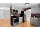 Modern kitchen with stainless steel appliances, grey cabinets, and brick backsplash at 3293 S Fairplay St, Aurora, CO 80014