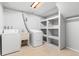 Laundry room with washer, dryer, utility sink and shelving at 3293 S Fairplay St, Aurora, CO 80014