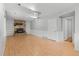 Cozy living room with a brick fireplace, built-in shelves, and hardwood floors at 3293 S Fairplay St, Aurora, CO 80014