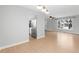 Open concept living area with hardwood floors, neutral walls, and view into the kitchen at 3293 S Fairplay St, Aurora, CO 80014