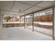 Covered patio with concrete floor, stone planter wall, and backyard access at 3293 S Fairplay St, Aurora, CO 80014