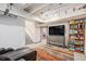 Basement with a cozy seating area, storage, and stairs at 26385 E Canal Pl, Aurora, CO 80018