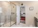 Modern bathroom features a glass-enclosed shower and an open doorway leading to a bedroom at 26385 E Canal Pl, Aurora, CO 80018