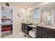 Bathroom with double sinks, granite counters, vanity area, and a glass-enclosed shower at 26385 E Canal Pl, Aurora, CO 80018