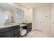 Bathroom with double sinks, granite counters, vanity area, and a glass-enclosed shower at 26385 E Canal Pl, Aurora, CO 80018