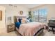 Bright bedroom with a comfortable bed, large window, and stylish decor at 26385 E Canal Pl, Aurora, CO 80018