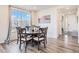 Cozy dining room with wood floors and a large picture window at 26385 E Canal Pl, Aurora, CO 80018