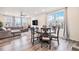 Bright living room and dining area with wood floors, a sectional sofa, and a dining table at 26385 E Canal Pl, Aurora, CO 80018