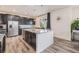 Well-lit kitchen with stainless steel appliances, granite countertops, dark cabinets and wood flooring at 26385 E Canal Pl, Aurora, CO 80018