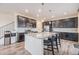 Contemporary kitchen with stainless steel appliances, dark wood cabinets, granite countertops and a large island at 26385 E Canal Pl, Aurora, CO 80018