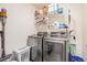 Well-equipped laundry room with modern washer and dryer, storage shelves, and ample space at 26385 E Canal Pl, Aurora, CO 80018