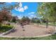 Community playground with swings, slides, and play structures for children at 26385 E Canal Pl, Aurora, CO 80018