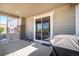 Covered porch with sliding glass door and space for outdoor dining at 26385 E Canal Pl, Aurora, CO 80018