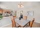 Inviting dining room with a stylish table, chairs, and decorative lighting fixture at 19481 E 50Th Pl, Denver, CO 80249