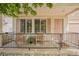 Inviting front porch features charming furniture, decorative shutters, and a secure black metal railing at 19481 E 50Th Pl, Denver, CO 80249