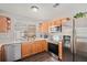 Well-lit kitchen featuring stainless steel appliances, light wood cabinetry, and a bright window at 19481 E 50Th Pl, Denver, CO 80249