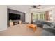 Cozy living room with a large sectional sofa, entertainment center with fireplace, and bright natural light at 19481 E 50Th Pl, Denver, CO 80249