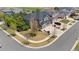 Aerial view of a gray home with a three car garage in a neighborhood with green grass and walking paths at 15915 E Summit Fox Ave, Parker, CO 80134