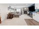 Stylish finished basement featuring a cozy seating area, stone fireplace, and modern wet bar at 15915 E Summit Fox Ave, Parker, CO 80134