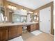 Bathroom with a double sink vanity, seated makeup area, and separate glass enclosed shower at 15915 E Summit Fox Ave, Parker, CO 80134