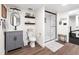 Modern basement bathroom featuring a sleek vanity, toilet, and glass-enclosed shower with a bench at 15915 E Summit Fox Ave, Parker, CO 80134