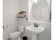 Updated half bathroom with modern fixtures, a pedestal sink, and fresh paint at 15915 E Summit Fox Ave, Parker, CO 80134