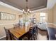 Formal dining room featuring a wooden table and chairs, with an open view of the living room at 15915 E Summit Fox Ave, Parker, CO 80134
