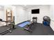 Basement gym area with exercise equipment, a mirror, and storage for a complete workout experience at 15915 E Summit Fox Ave, Parker, CO 80134