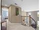 Second floor hallway features wood banister, art niche and open views to lower level at 15915 E Summit Fox Ave, Parker, CO 80134