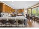 Bright kitchen features an island with bar seating and opens to a dining area with backyard views at 15915 E Summit Fox Ave, Parker, CO 80134