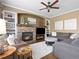 Well-lit living room showcases a stone fireplace, built-in shelving, and plush seating for comfortable living at 15915 E Summit Fox Ave, Parker, CO 80134