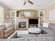 Comfortable living room features a stone fireplace and built-in shelving, creating a relaxing atmosphere at 15915 E Summit Fox Ave, Parker, CO 80134
