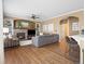 Spacious living room boasts a cozy fireplace with stone surround and custom built-in shelving at 15915 E Summit Fox Ave, Parker, CO 80134